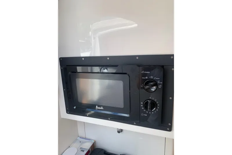 Slide: The Image of Built-in Avanti microwave in 2008 Intrepid 370 Cuddy boat interior. - 16