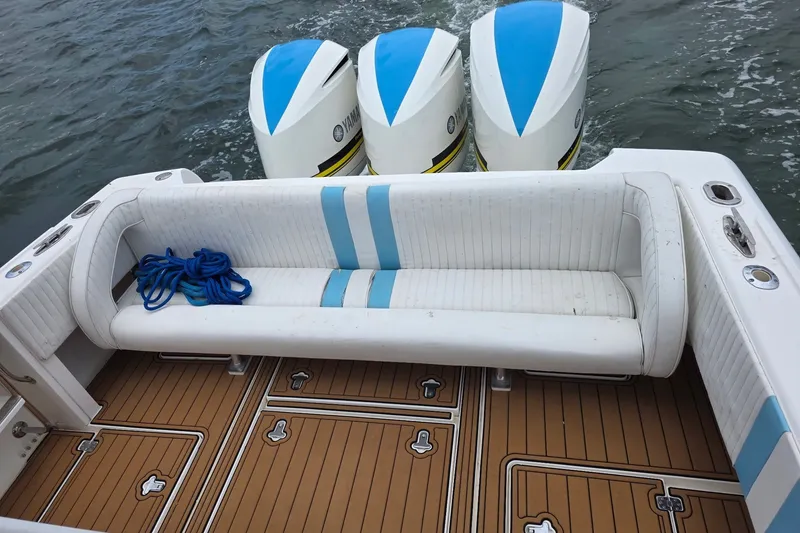Slide: The Image of 2008 Intrepid 370 Cuddy boat with triple Yamaha engines and cushioned seating. - 8
