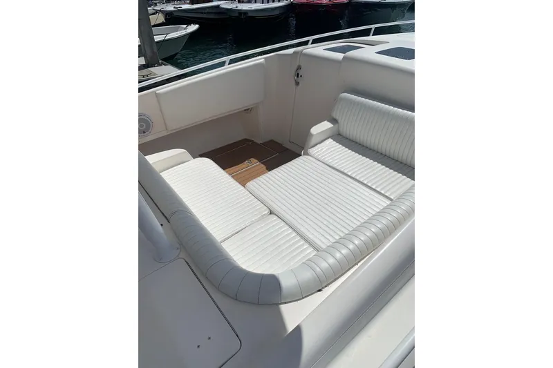 Slide: The Image of 2008 Intrepid 370 Cuddy boat interior with white cushioned seating. - 18