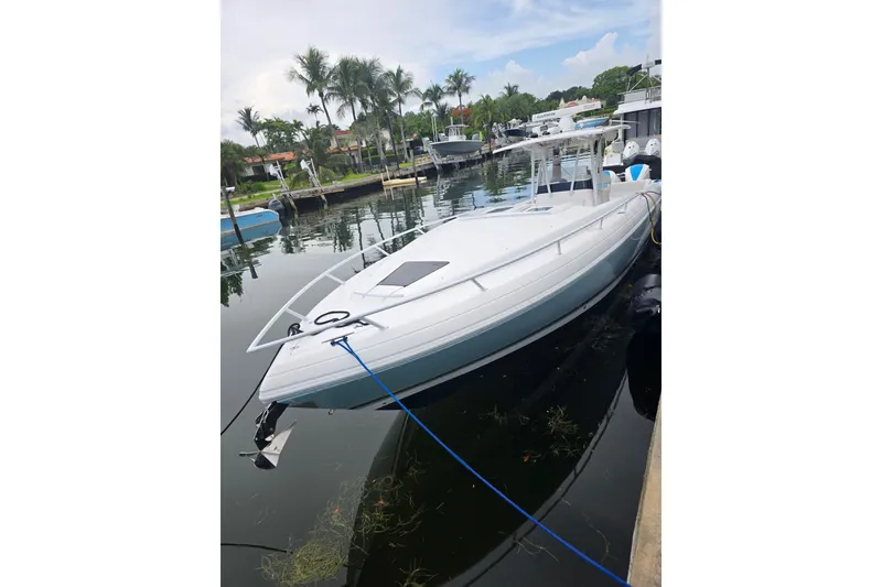 Slide: The Image of 2008 Intrepid 370 Cuddy boat docked in a serene marina setting. - 3