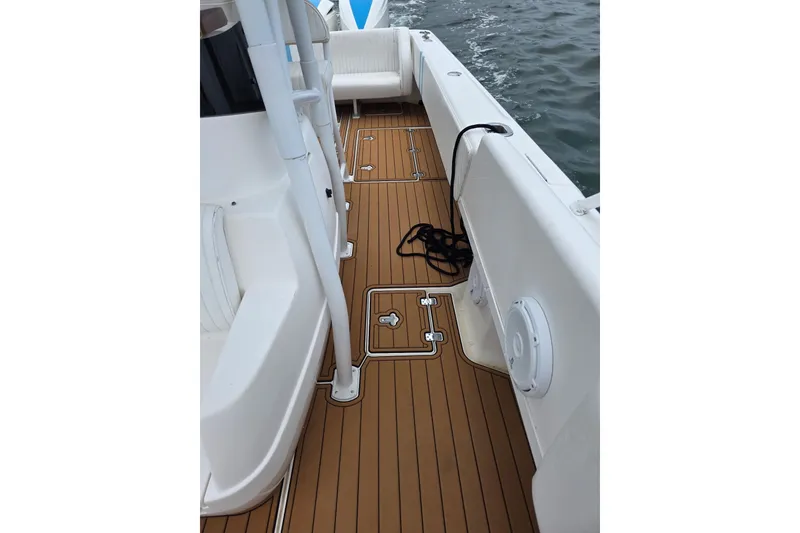 Slide: The Image of 2008 Intrepid 370 Cuddy boat deck with teak flooring and white seating. - 7