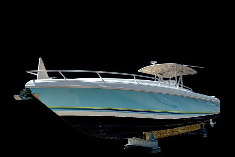 Slide: The Image of 2008 Intrepid 370 Cuddy boat on stand, sleek design, blue hull, black background. - 10