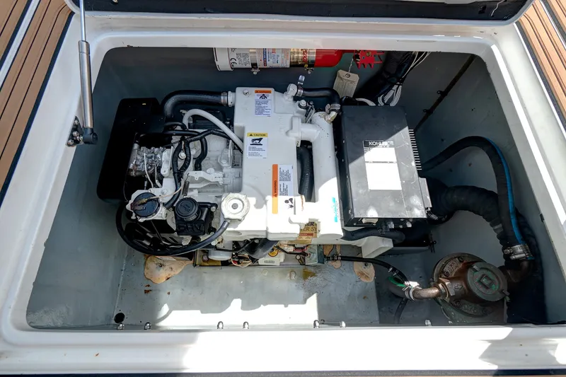 Slide: The Image of Engine compartment of a 2008 Intrepid 370 Cuddy boat, featuring a Kohler generator. - 14