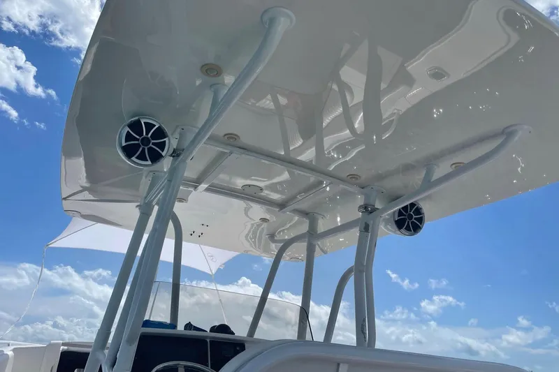 Slide: The Image of 2008 Intrepid 370 Cuddy boat's T-top with speakers against a blue sky. - 25