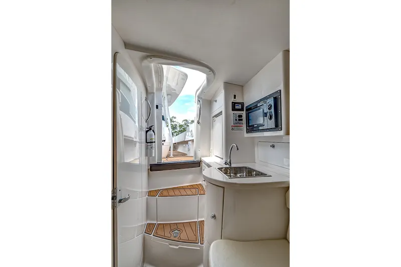 Slide: The Image of Interior view of 2008 Intrepid 370 Cuddy, featuring a compact kitchenette and modern amenities. - 22