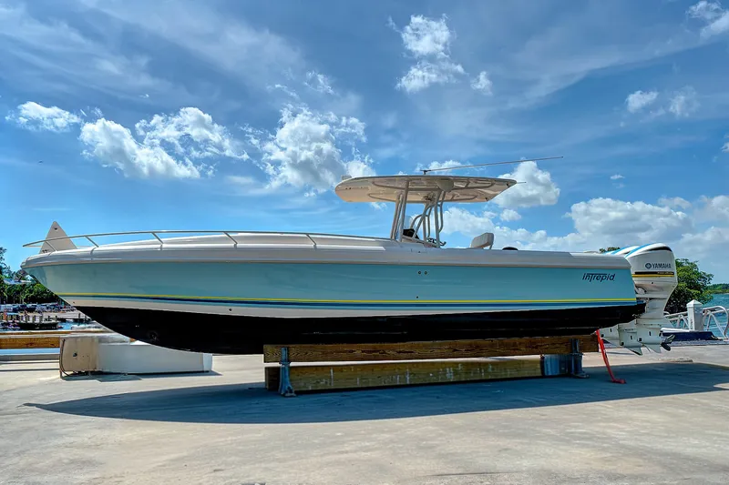 Slide: The Image of 2008 Intrepid 370 Cuddy boat on display under a clear blue sky. - 11