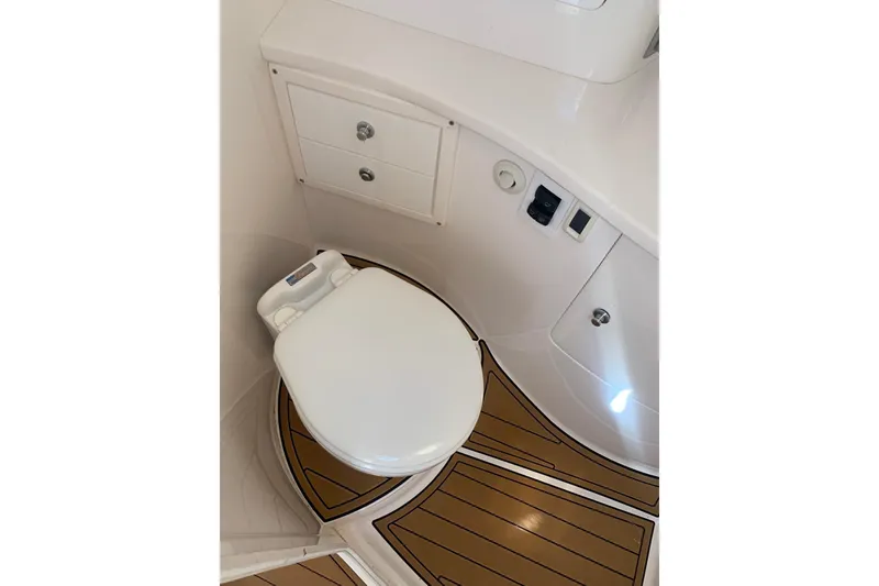 Slide: The Image of 2008 Intrepid 370 Cuddy boat bathroom with toilet and storage cabinets. - 17
