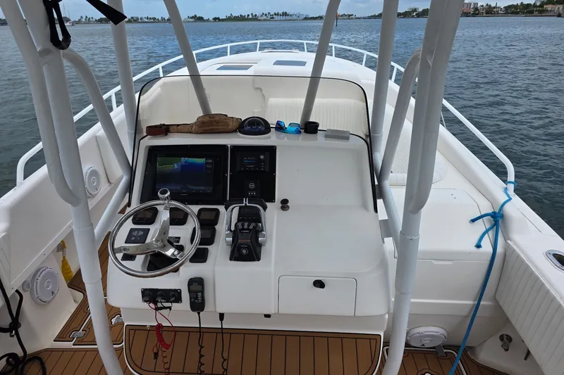 Slide: The Image of Cockpit view of 2008 Intrepid 370 Cuddy boat with steering wheel and navigation controls. - 5