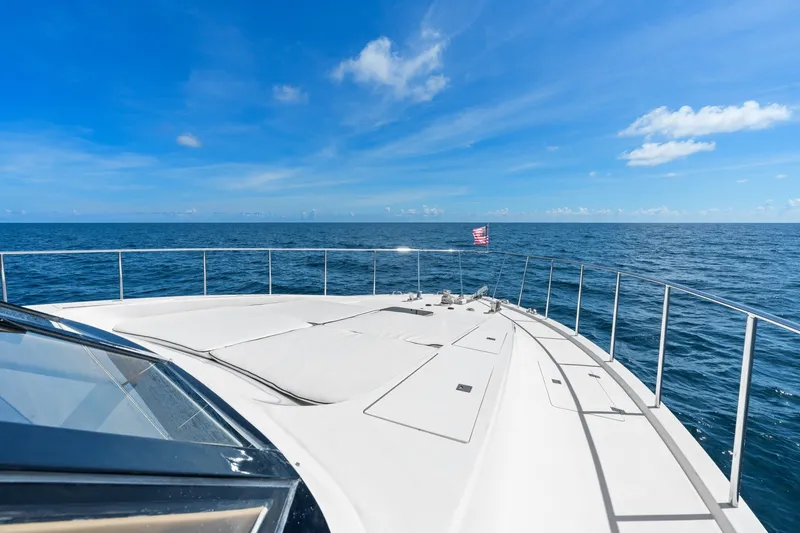 Slide: The Image of 1998 Cheoy Lee Motor Yacht cruising on open sea under clear blue sky. - 78