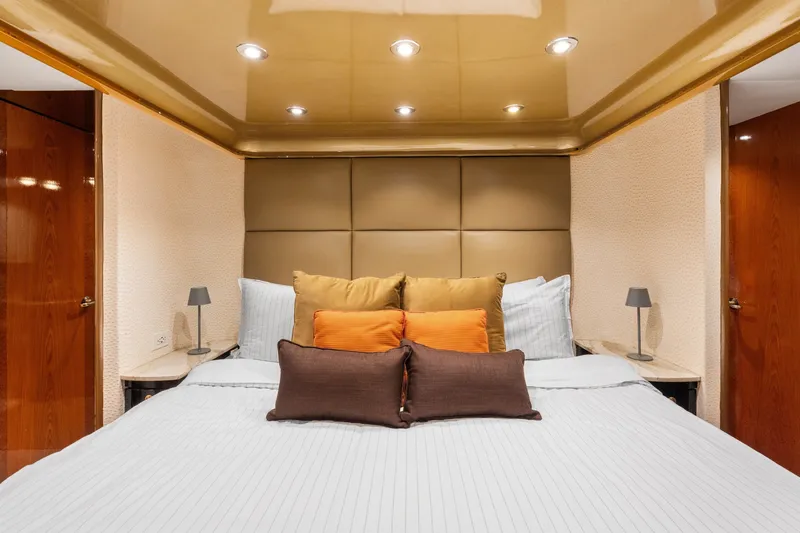 Slide: The Image of Luxurious bedroom interior on a 1998 Cheoy Lee Motor Yacht with elegant bedding and lighting. - 26