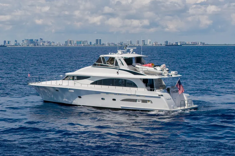 Slide: The Image of 1998 Cheoy Lee Motor Yacht cruising on ocean with city skyline in background. - 1
