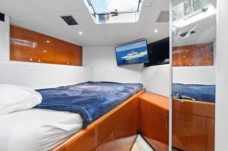 Slide: The Image of Luxurious 1998 Cheoy Lee Motor Yacht cabin with cozy bed, TV, and skylight. - 44