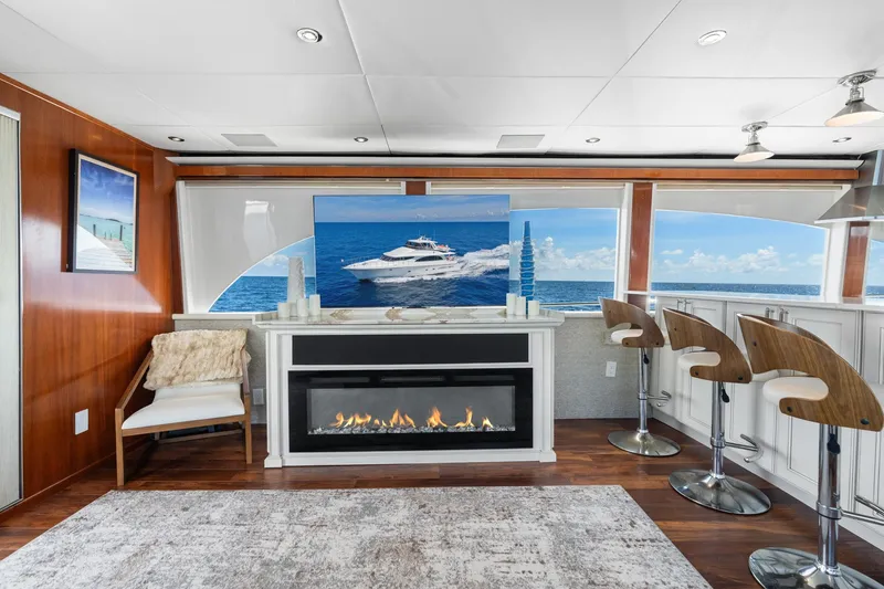 Slide: The Image of Luxurious interior of a 1998 Cheoy Lee Motor Yacht with modern fireplace and ocean view. - 11