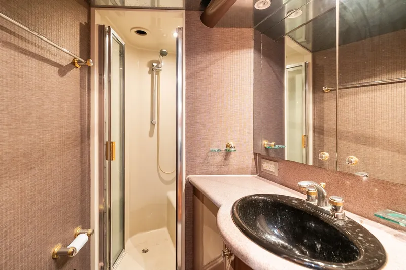 Slide: The Image of Luxurious bathroom in 1998 Cheoy Lee Motor Yacht with shower and black sink. - 46