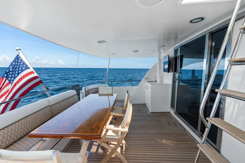 Slide: The Image of Luxurious 1998 Cheoy Lee Motor Yacht deck with ocean view and American flag. - 71