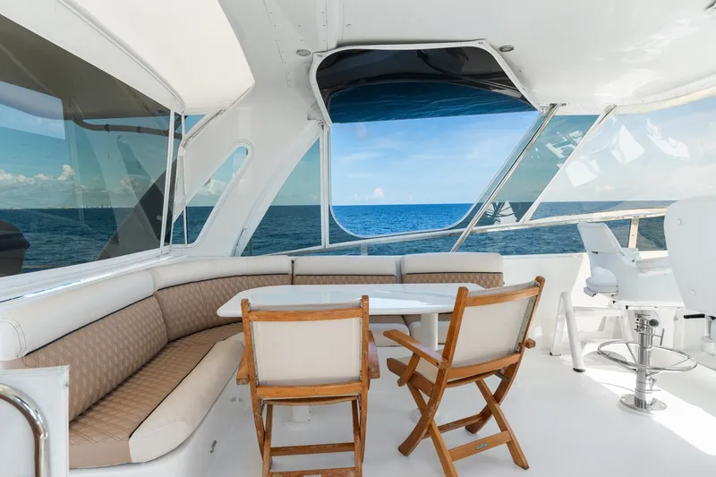 Slide: The Image of Luxurious 1998 Cheoy Lee Motor Yacht interior with ocean view, featuring elegant seating and dining area. - 51
