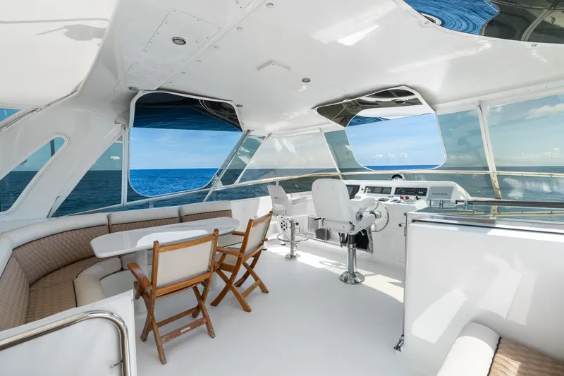 Slide: The Image of Luxurious 1998 Cheoy Lee Motor Yacht interior with ocean view, featuring elegant seating and helm. - 50