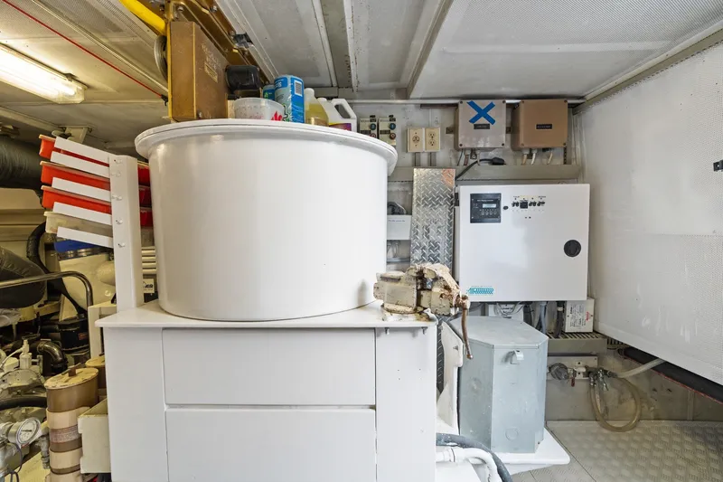 Slide: The Image of Engine room of a 1998 Cheoy Lee Motor Yacht with equipment and storage. - 90