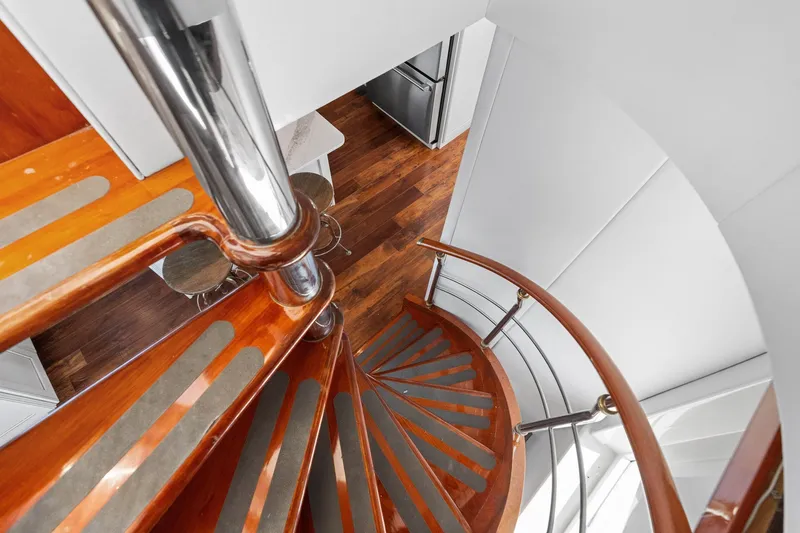 Slide: The Image of Spiral staircase on 1998 Cheoy Lee Motor Yacht with polished wood and metal accents. - 14