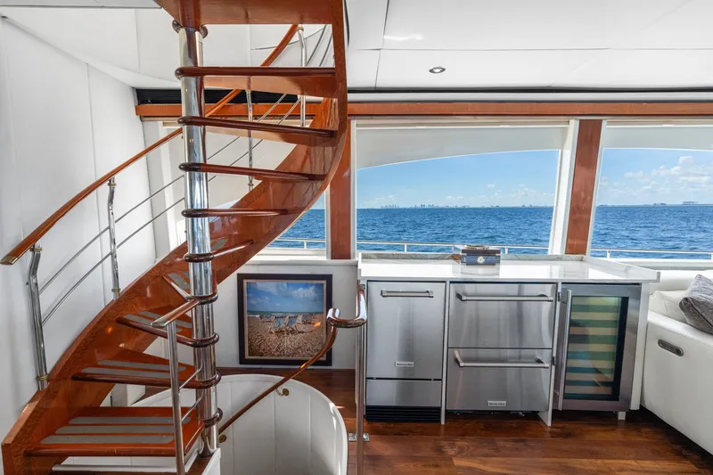 Slide: The Image of Luxurious 1998 Cheoy Lee Motor Yacht interior with elegant spiral staircase and ocean view. - 12