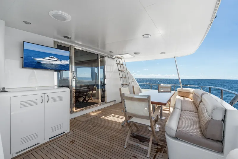 Slide: The Image of Luxurious 1998 Cheoy Lee Motor Yacht deck with seating, table, and ocean view. - 70