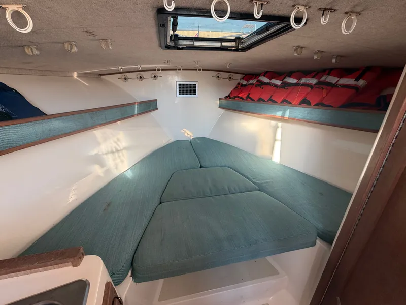 Slide: The Image of Interior of a 1999 Carolina Classic 28 with cushioned seating and life jackets. - 18