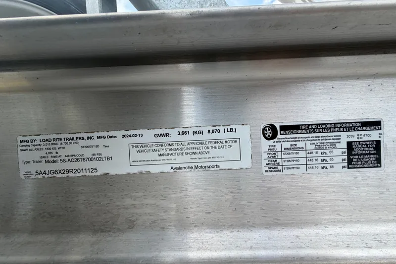 Slide: The Image of Trailer information labels on Load Rite Trailers, detailing specifications and safety standards. - 84
