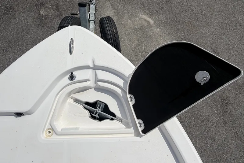 Slide: The Image of An open storage compartment on a white boat with a black lid. - 45