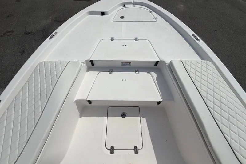 Slide: The Image of The image shows the bow deck of a Sea Fox 251 Bay Fox boat with cushioned seating. - 40