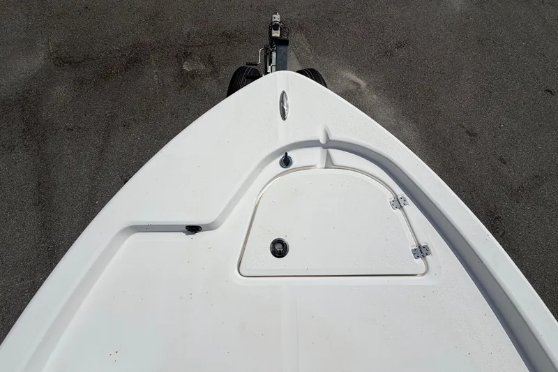 Slide: The Image of The 2025 Sea Fox 251 Bay Fox features a clean, white bow view with storage compartment. - 44