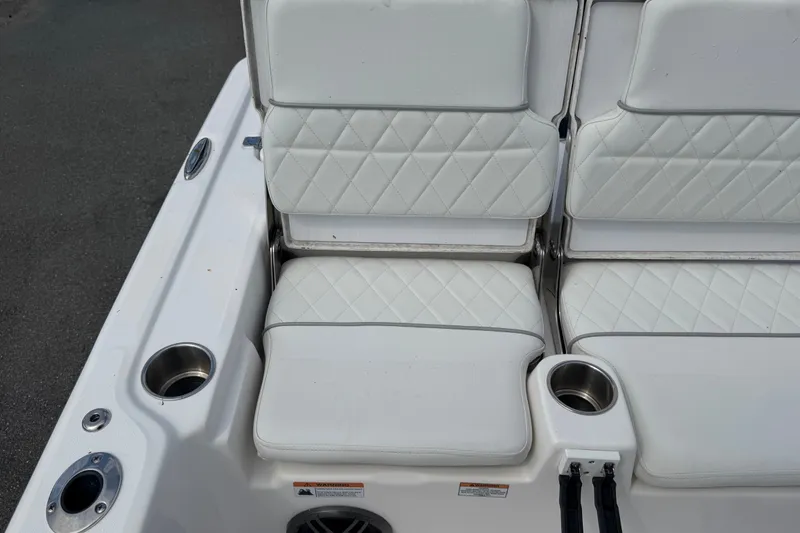 Slide: The Image of 2025 Sea Fox 251 Bay Fox boat seating with cup holders and diamond-stitched upholstery. - 68