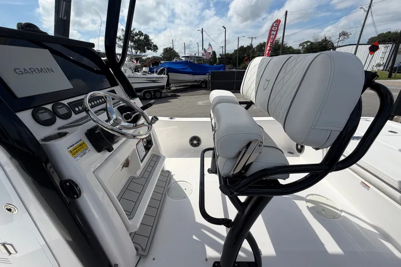 Slide: The Image of 2025 Sea Fox 251 Bay Fox boat interior with Garmin system and cushioned seating. - 18