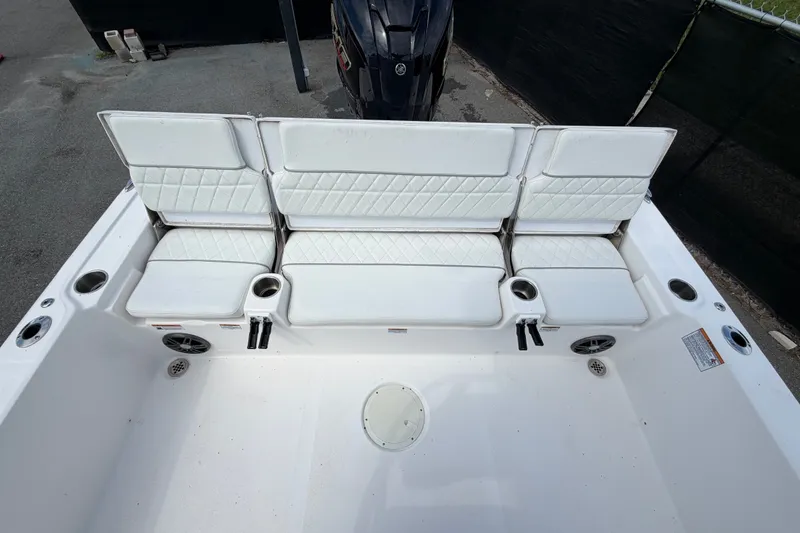 Slide: The Image of 2025 Sea Fox 251 Bay Fox boat interior with white cushioned seating and cup holders. - 67