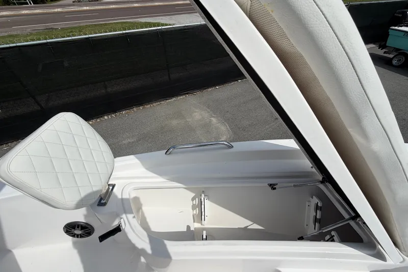 Slide: The Image of 2025 Sea Fox 251 Bay Fox boat interior with open storage compartment and cushioned seat. - 50