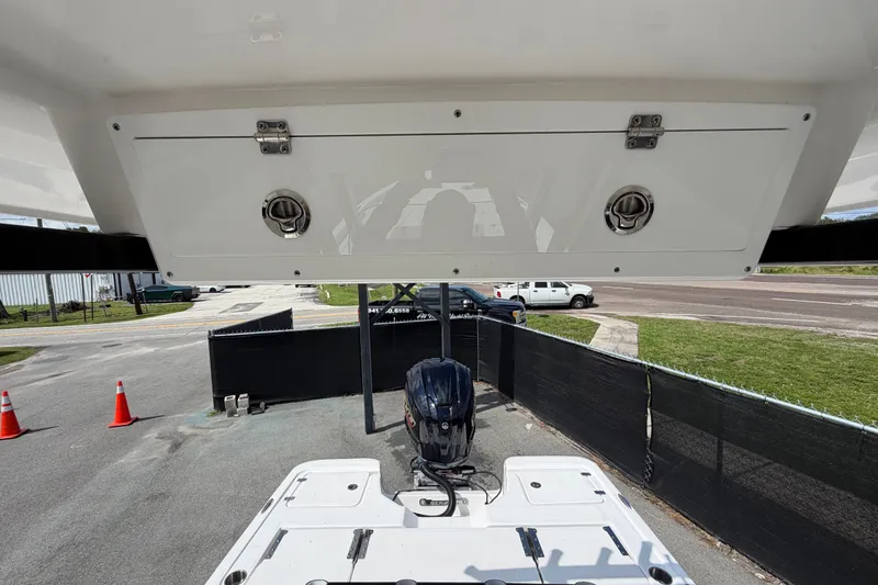 Slide: The Image of 2025 Sea Fox 251 Bay Fox boat with motor, viewed from above, in a parking area. - 61