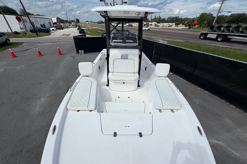 Slide: The Image of 2025 Sea Fox 251 Bay Fox boat with white seating, parked on a paved lot. - 47