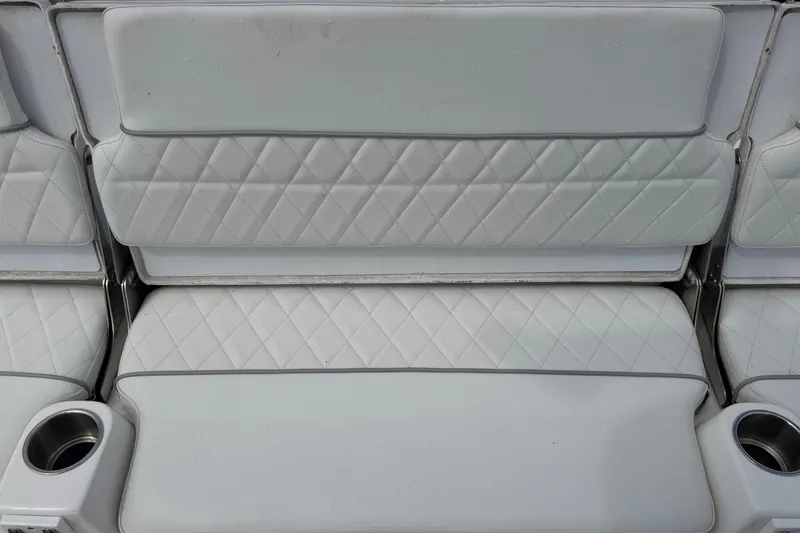 Slide: The Image of 2025 Sea Fox 251 Bay Fox boat seat with diamond-pattern upholstery and integrated cup holders. - 71