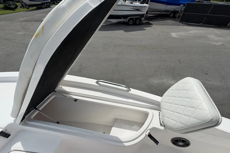Slide: The Image of Open storage compartment on 2025 Sea Fox 251 Bay Fox boat, featuring cushioned seating. - 52