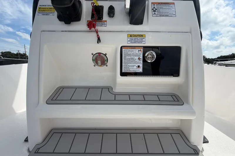 Slide: The Image of 2025 Sea Fox 251 Bay Fox boat console with safety warnings and storage compartment. - 29