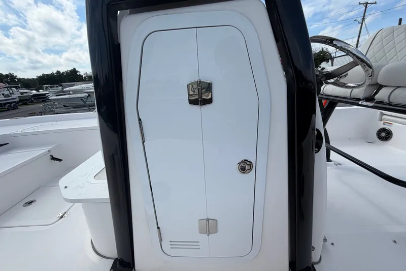 Slide: The Image of 2025 Sea Fox 251 Bay Fox boat console with storage compartment and steering wheel. - 34