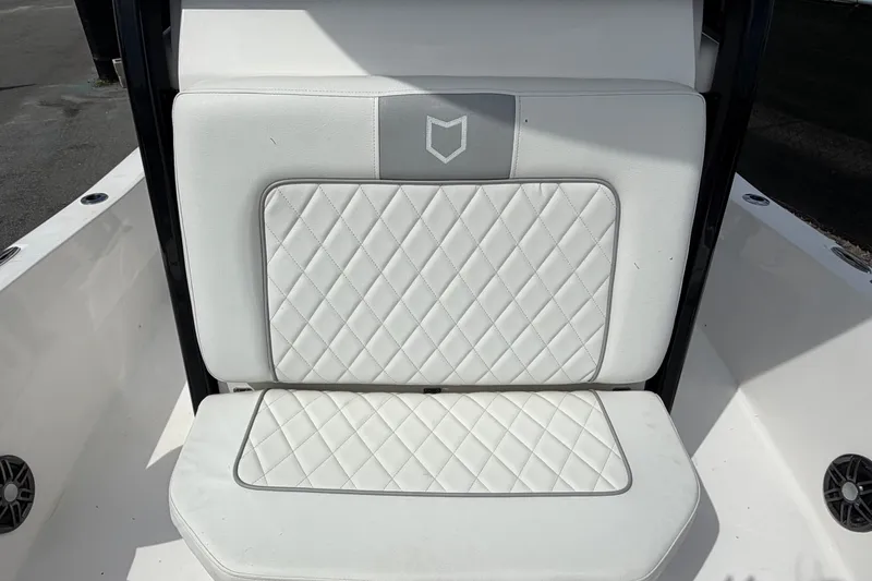 Slide: The Image of 2025 Sea Fox 251 Bay Fox boat seat with diamond-stitched white upholstery. - 57