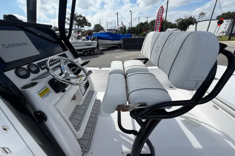 Slide: The Image of 2025 Sea Fox 251 Bay Fox boat interior with Garmin navigation and cushioned seating. - 17