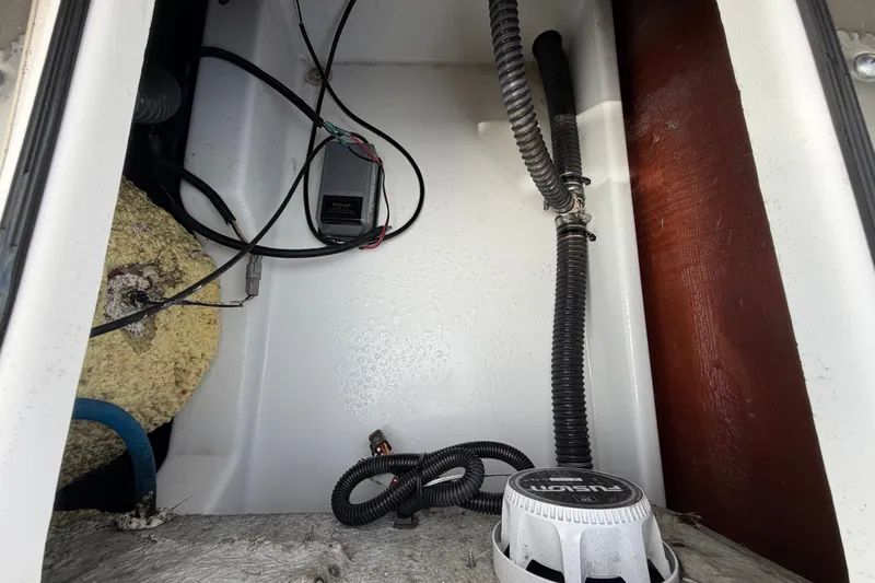 Slide: The Image of Interior view of a 2025 Sea Fox 251 Bay Fox boat compartment with wiring and components. - 75