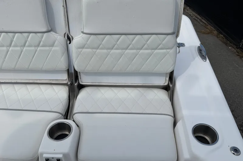 Slide: The Image of White cushioned seating on 2025 Sea Fox 251 Bay Fox boat with cup holders. - 73