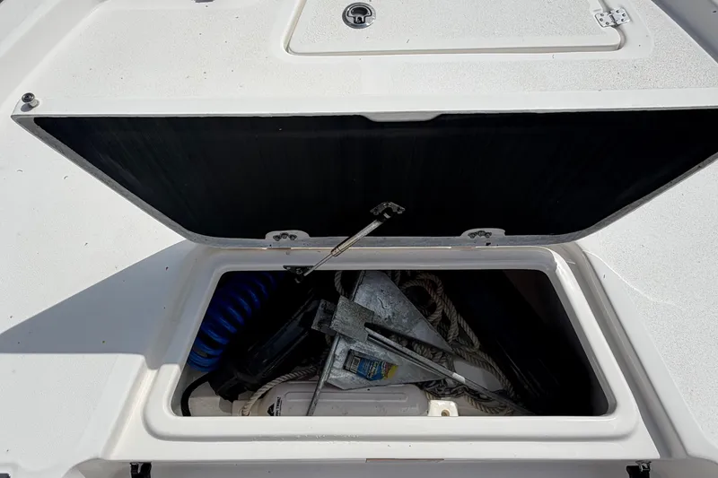 Slide: The Image of An open storage compartment on a Sea Fox 251 Bay Fox boat, filled with ropes and equipment. - 43