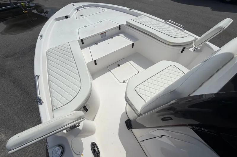 Slide: The Image of 2025 Sea Fox 251 Bay Fox boat interior with white cushioned seating and storage compartments. - 39