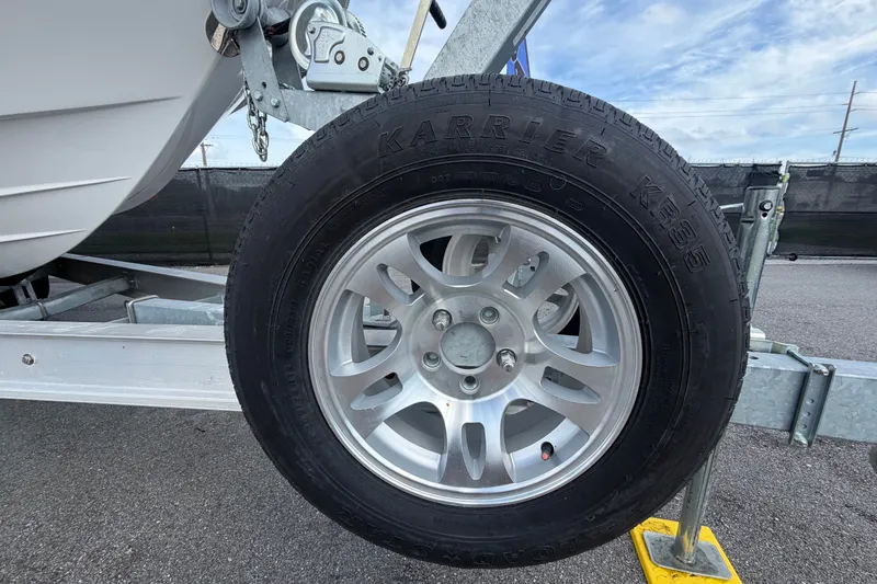 Slide: The Image of Trailer wheel of 2025 Sea Fox 251 Bay Fox boat on pavement. - 86