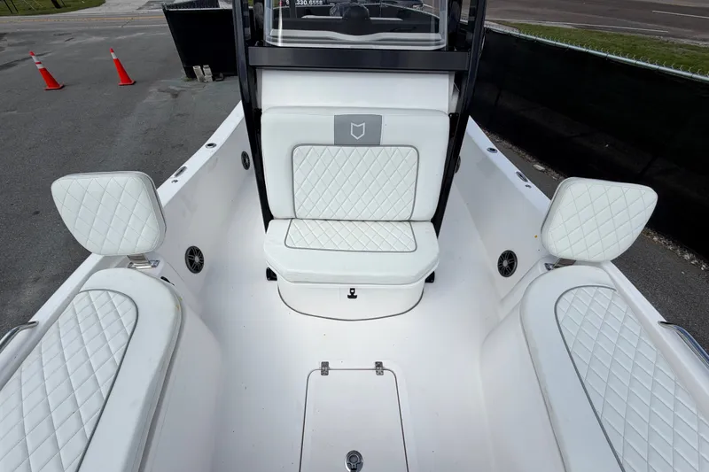 Slide: The Image of 2025 Sea Fox 251 Bay Fox boat interior with white quilted seating and modern design. - 53