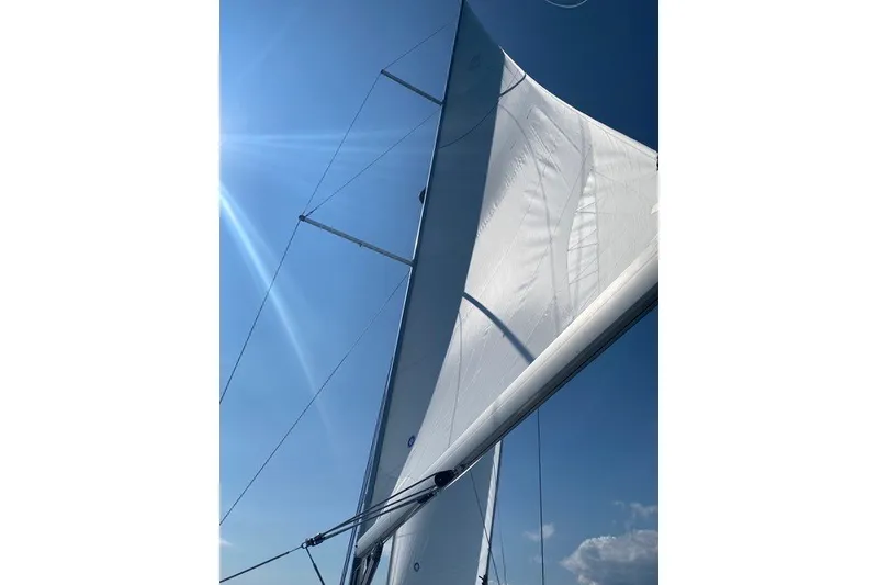 Slide: The Image of Sailing yacht Beneteau Oceanis 40.1, 2021 model, with sails unfurled against a clear blue sky. - 5