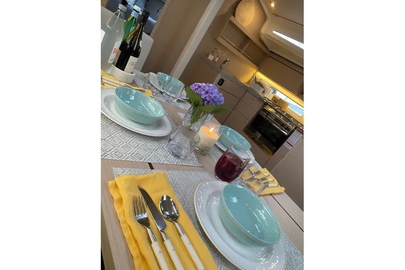 Slide: The Image of Elegant dining setup in a 2021 Beneteau Oceanis 40.1 yacht interior. - 4